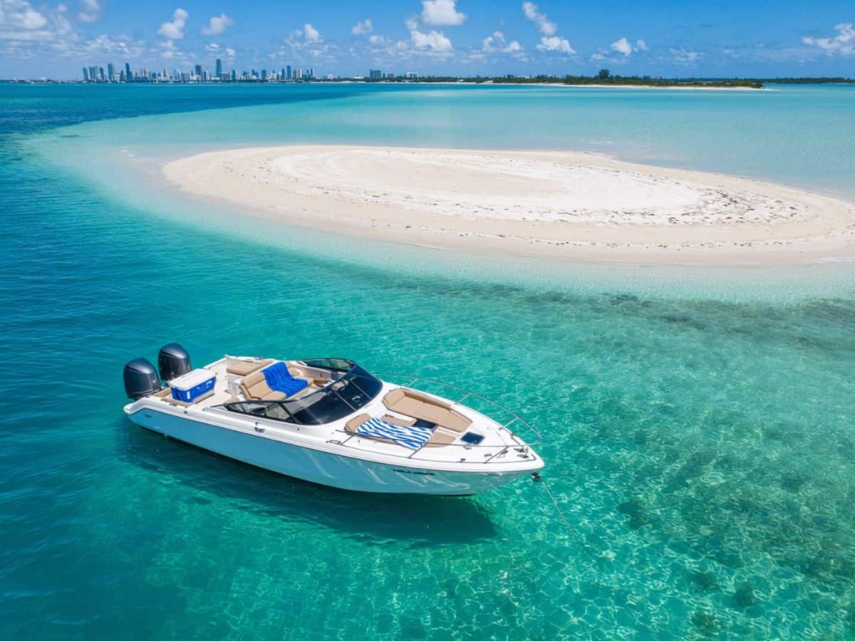 Speedboat anchored in turquoise water at a Miami sandbar